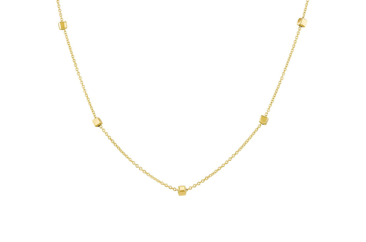 A delicate gold chain necklace featuring five small, evenly spaced square-cut gold beads, displayed against a solid white background.