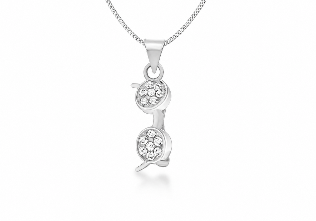 A silver pendant necklace featuring two stacked, vertically aligned oval charms, each adorned with a small cluster of clear pavé gemstones, suspended from a delicate silver chain against a white background.