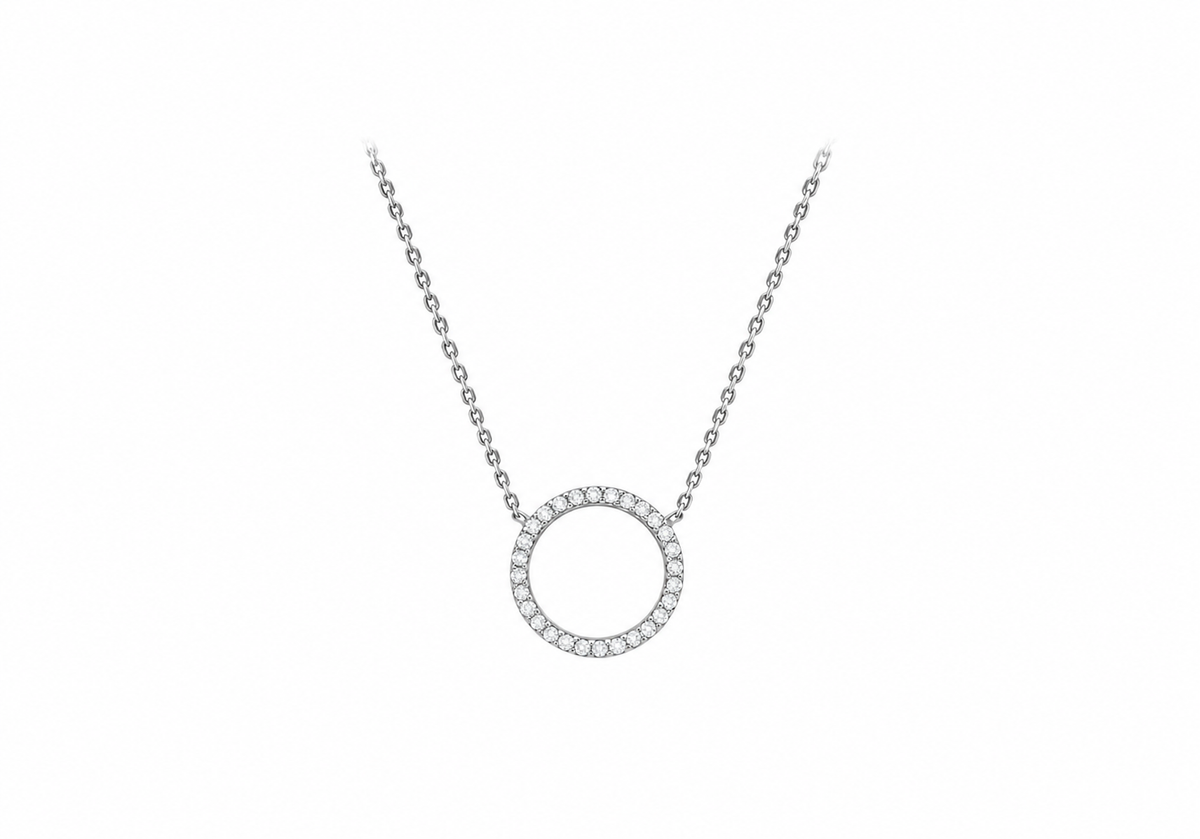 A silver-tone necklace featuring a circular pendant bordered with small clear stones, displayed on a plain white background.