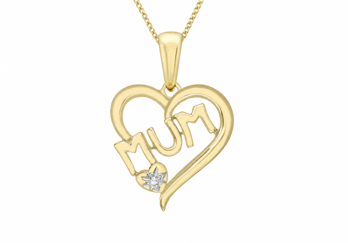 A yellow gold heart-shaped pendant necklace with the word 'Mum' cut into the center, featuring a small clear heart-shaped diamond accent, shown on a white background.