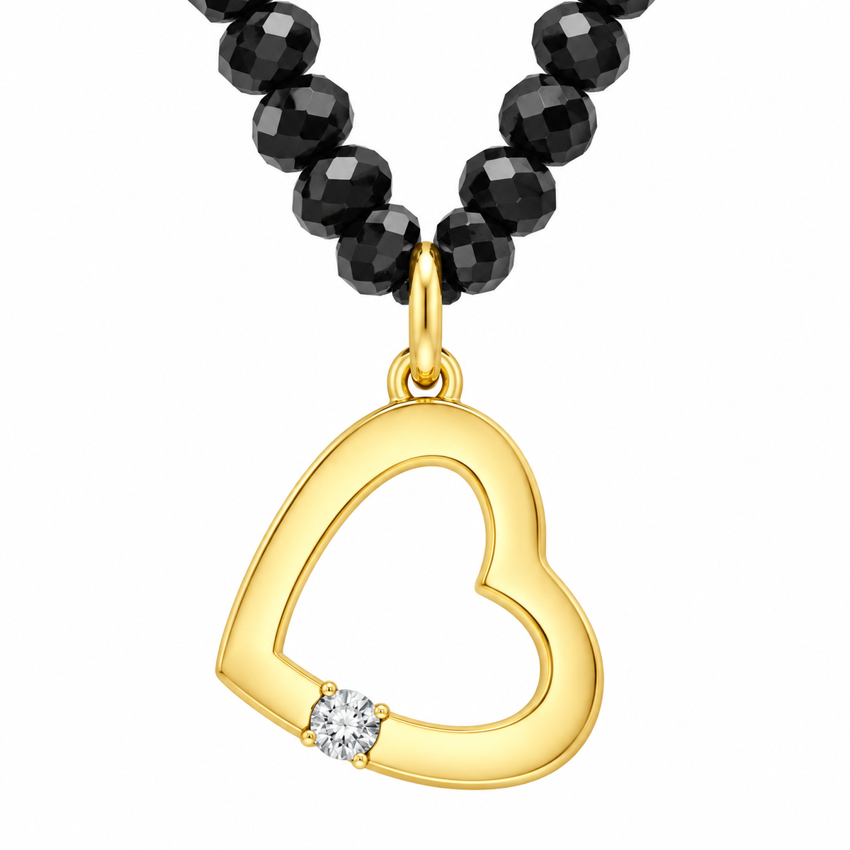 A gold heart-shaped pendant necklace with a small clear gemstone at the bottom left, suspended from a black faceted bead chain on a white background.
