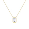 A delicate gold chain necklace featuring a rectangular emerald-cut clear gemstone pendant in a gold bezel setting, shown against a solid white background.