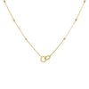 A delicate yellow gold chain necklace featuring small bead accents along the chain and a central double interlocking ring pendant, shown against a plain white background.

Details