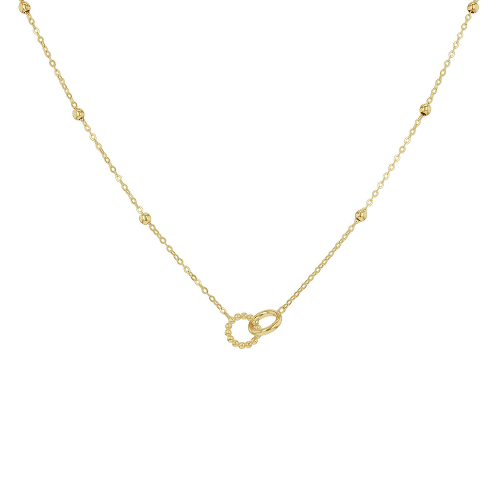 A delicate yellow gold chain necklace featuring small bead accents along the chain and a central double interlocking ring pendant, shown against a plain white background.

Details